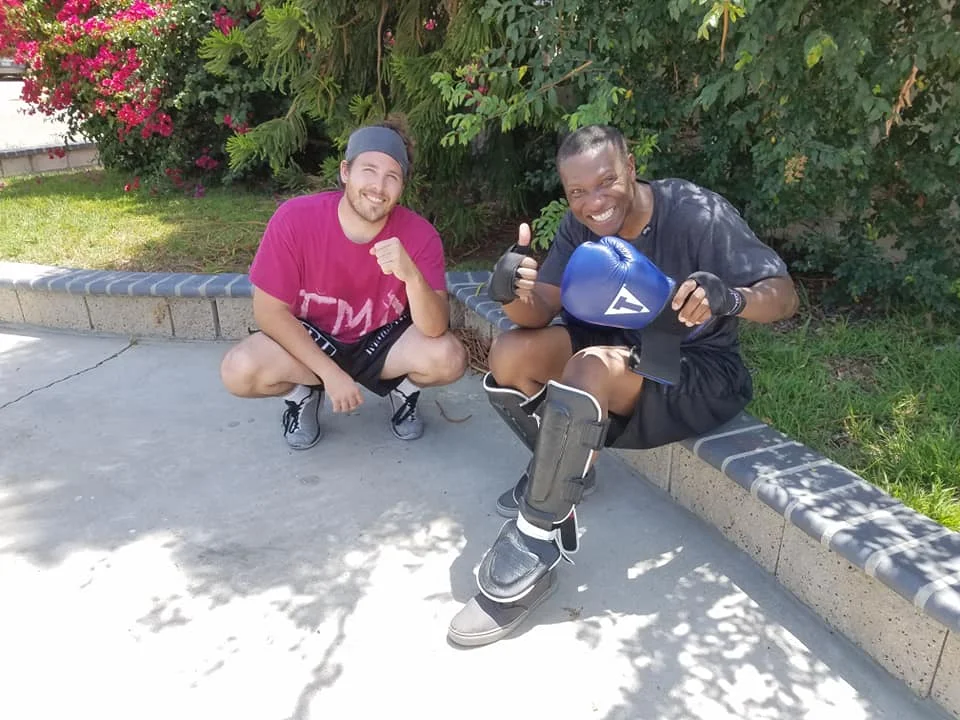 Top students Tim and Kojo rest after heavy sparring