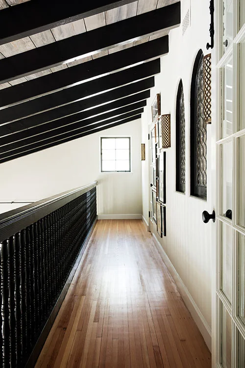 Second-Floor-Hall-with-Wood-Ceiling-Beams-Stucco-Walls-and-Turned-Balusters-Designed-by-Carol-Allen-of-Studio-Allen-Architects-and-Kishani-Perera.jpg
