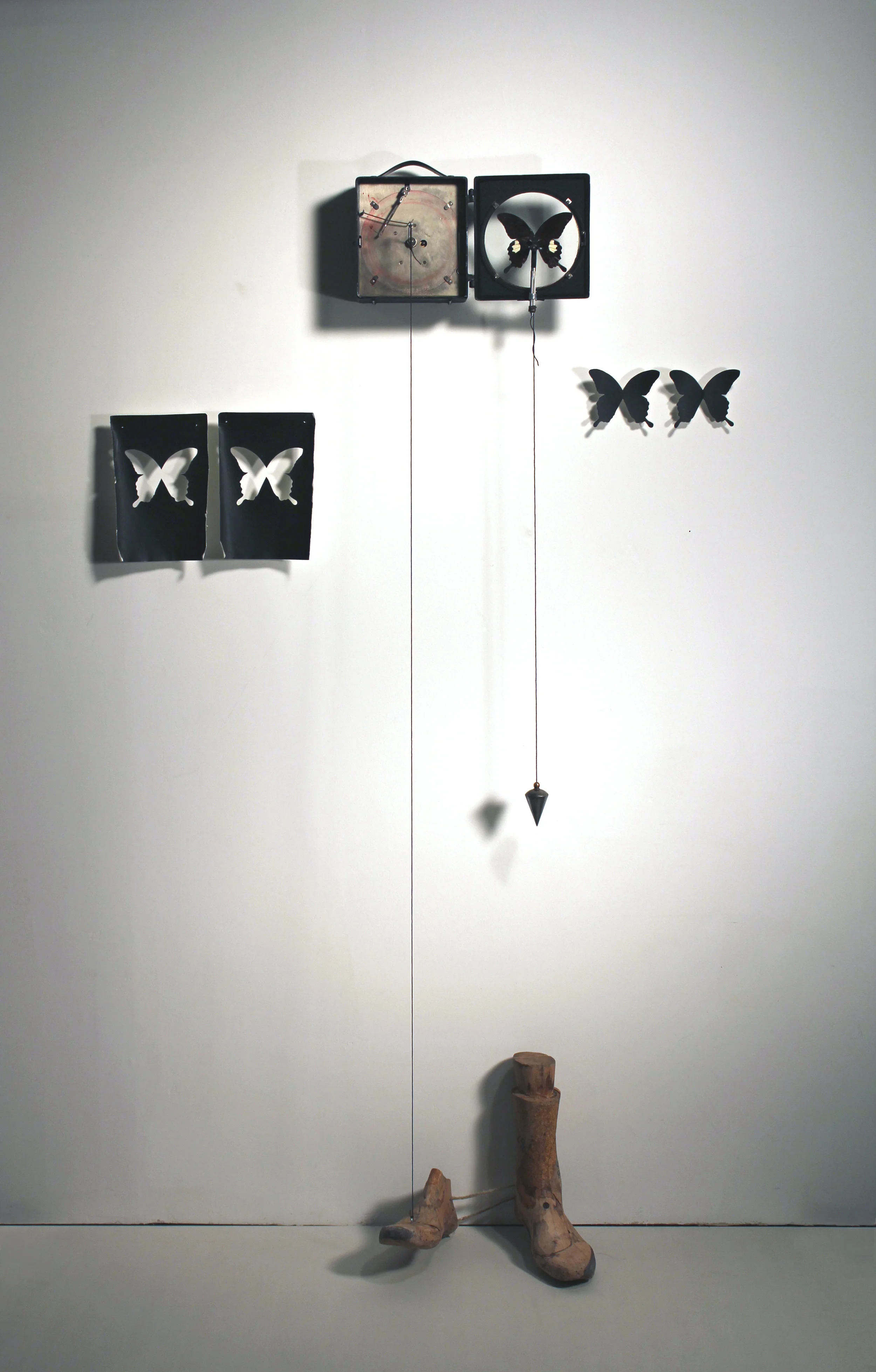 Long Wait for the Last Dance, Vintage air pressure recording device, butterfly, lead, string, wire, plumb line, paper,pins, and antique wooden feet. (Kinetic sculpture: the foot taps gradually once every 24 hours.) 2016