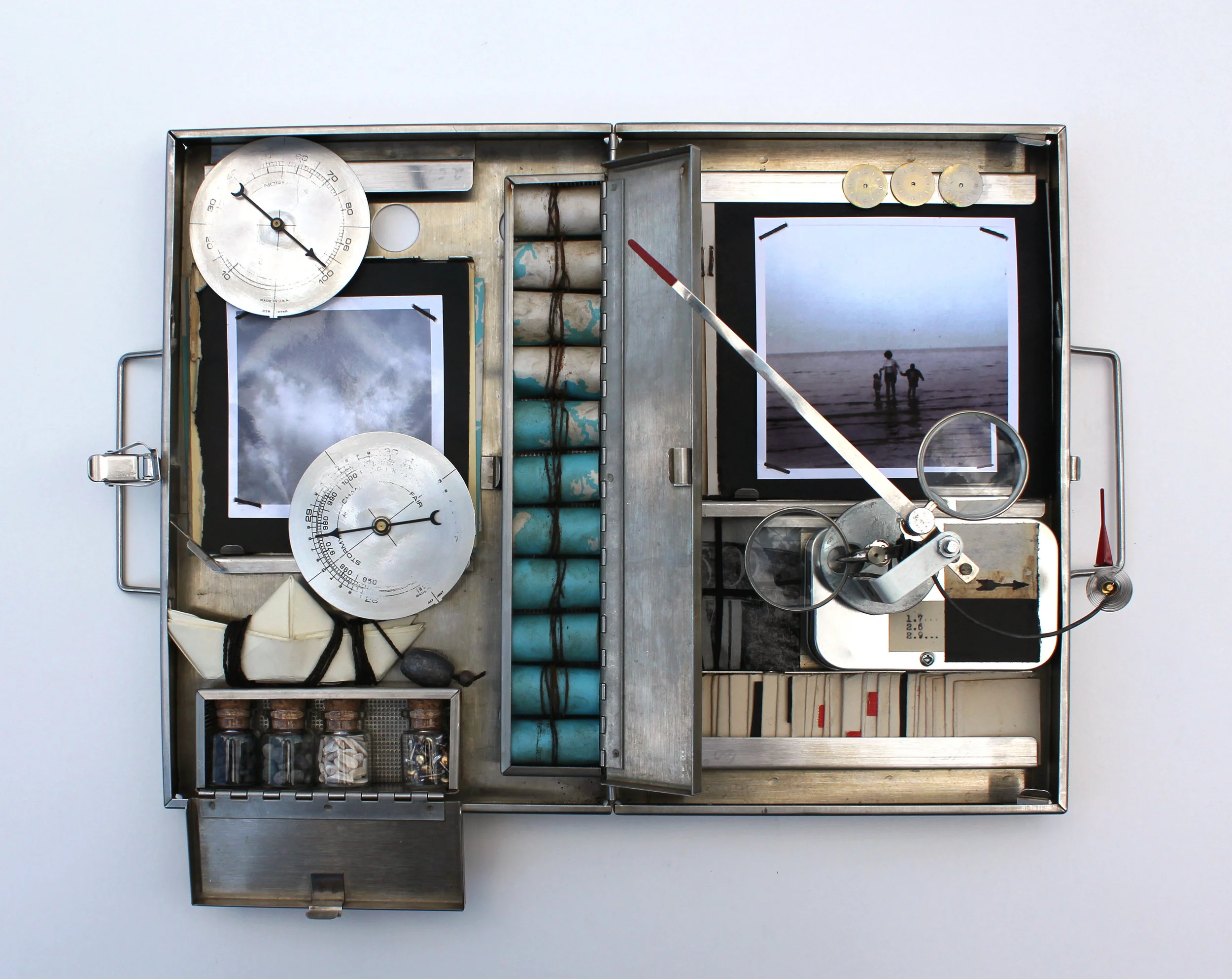 Children of the Sea (Music for Clouds), Vintage photos, maps, paper, wire, string, stones, ribbon, lead, barometer, optical lens, music box mechanism, in surgical box. (kinetic sculpture), 16 x 12 x 4 inches, 2016