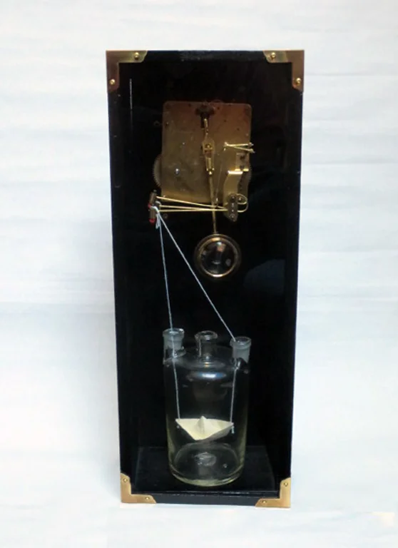 Waiting for Storms, 2015. (The chime mechanism of the clock rocks the boat in the glass flask.)