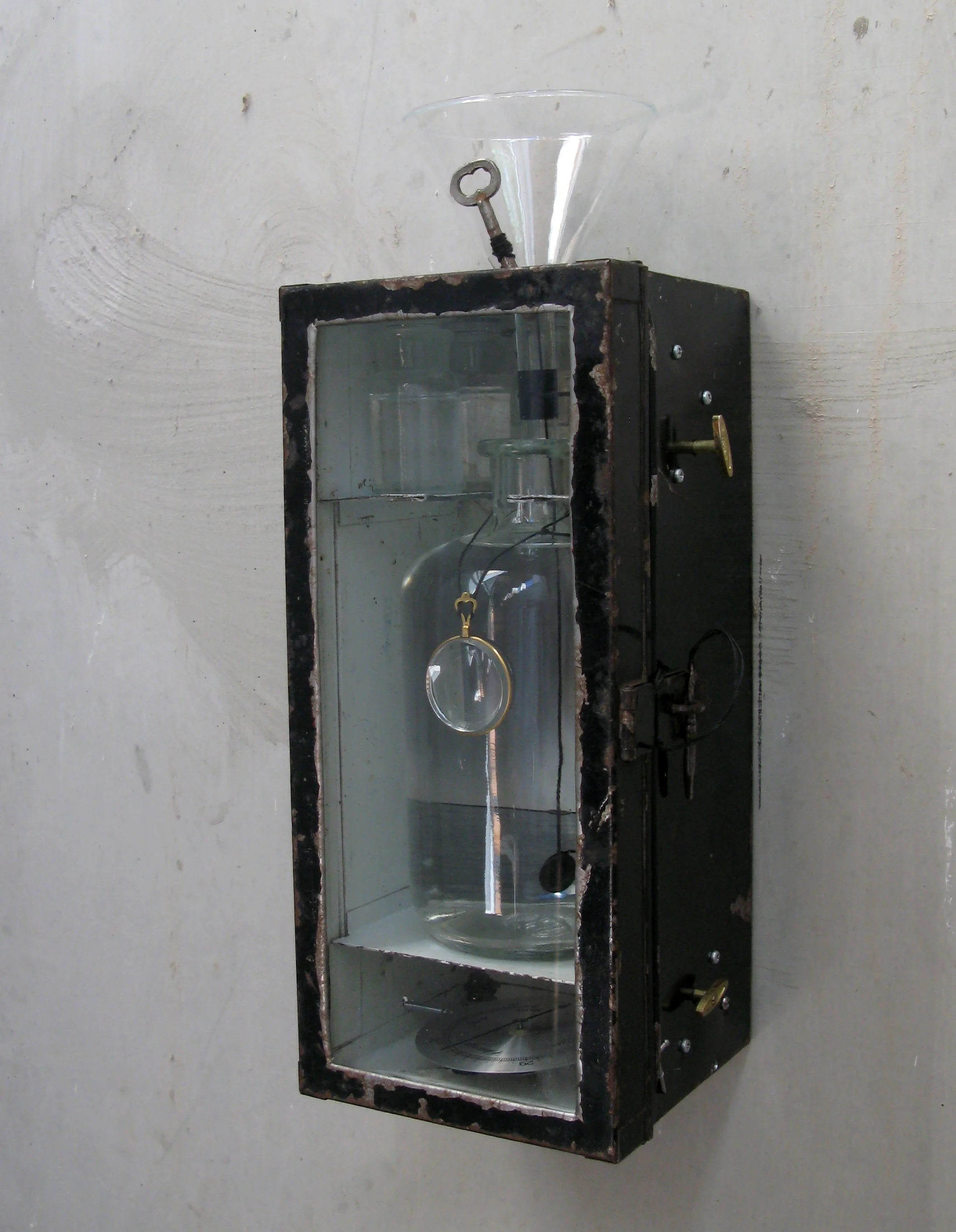 Rain Gauge, 2014. (Music box mechanisms cause the funnel and arrows to rotate as melancholy music plays.)