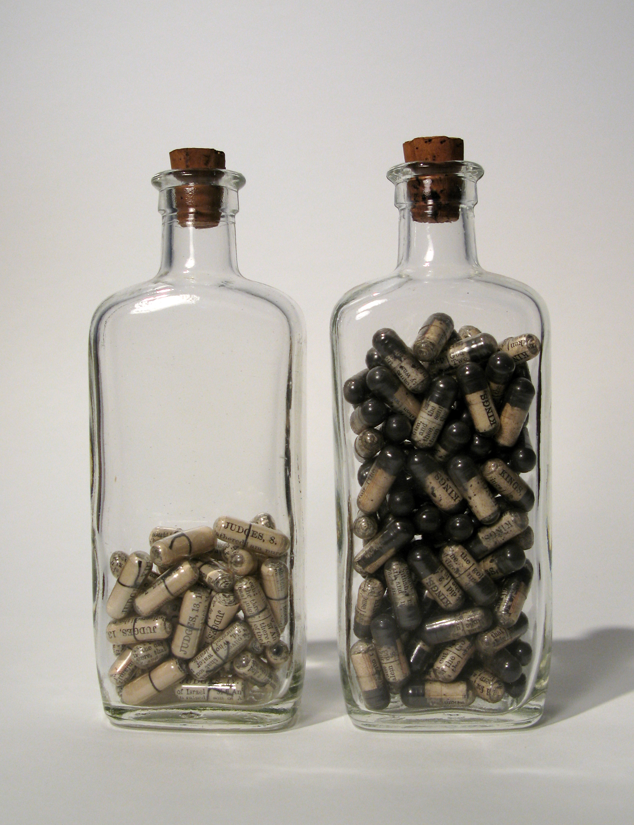Shock and Abomination, Bible pages, ashes, thread, gelatin capsules, antique bottles, cork, 5 x 6 x 1.5 inches, 2007.