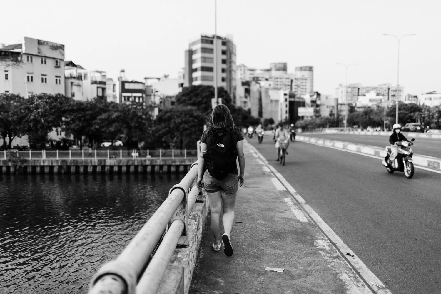 Traveler Overlooking City River - Urban Transit Scene