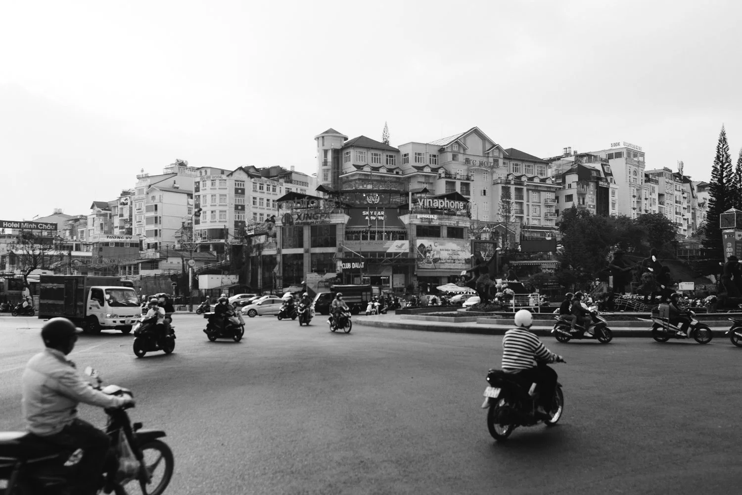 Busy City Square with Motorcyclists - Urban Life in Vietnam