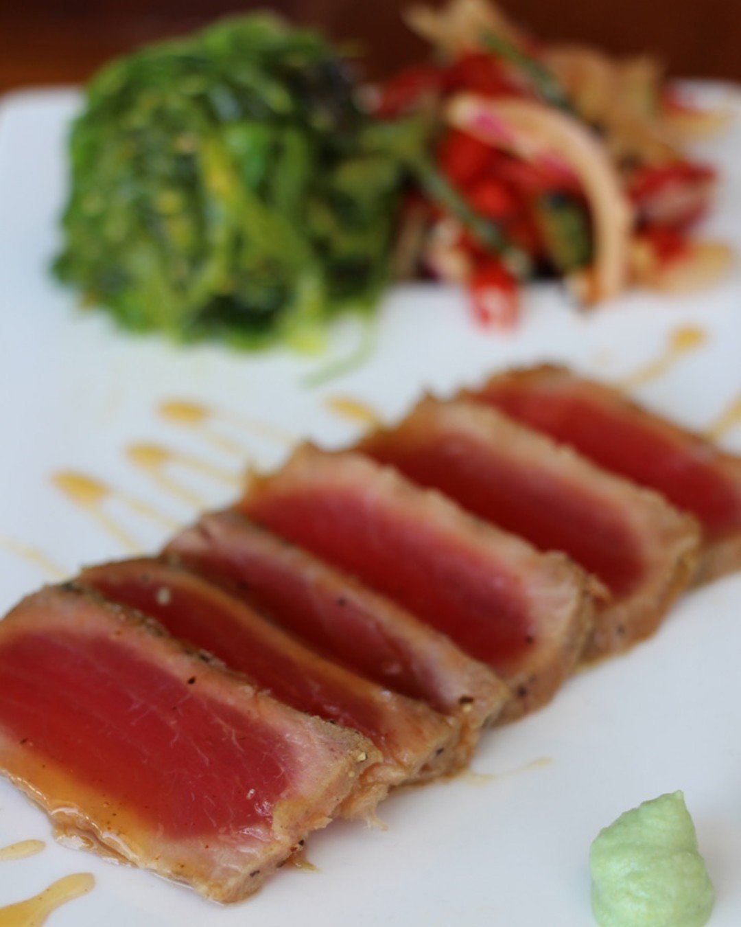 A taste of the ocean to your plate with this perfectly seared Ahi Tuna topped with a flavorful pepper and garlic crust, paired with a refreshing marinated cucumber salad and drizzled in a tangy soy-ginger glaze. And let's not forget about that delici