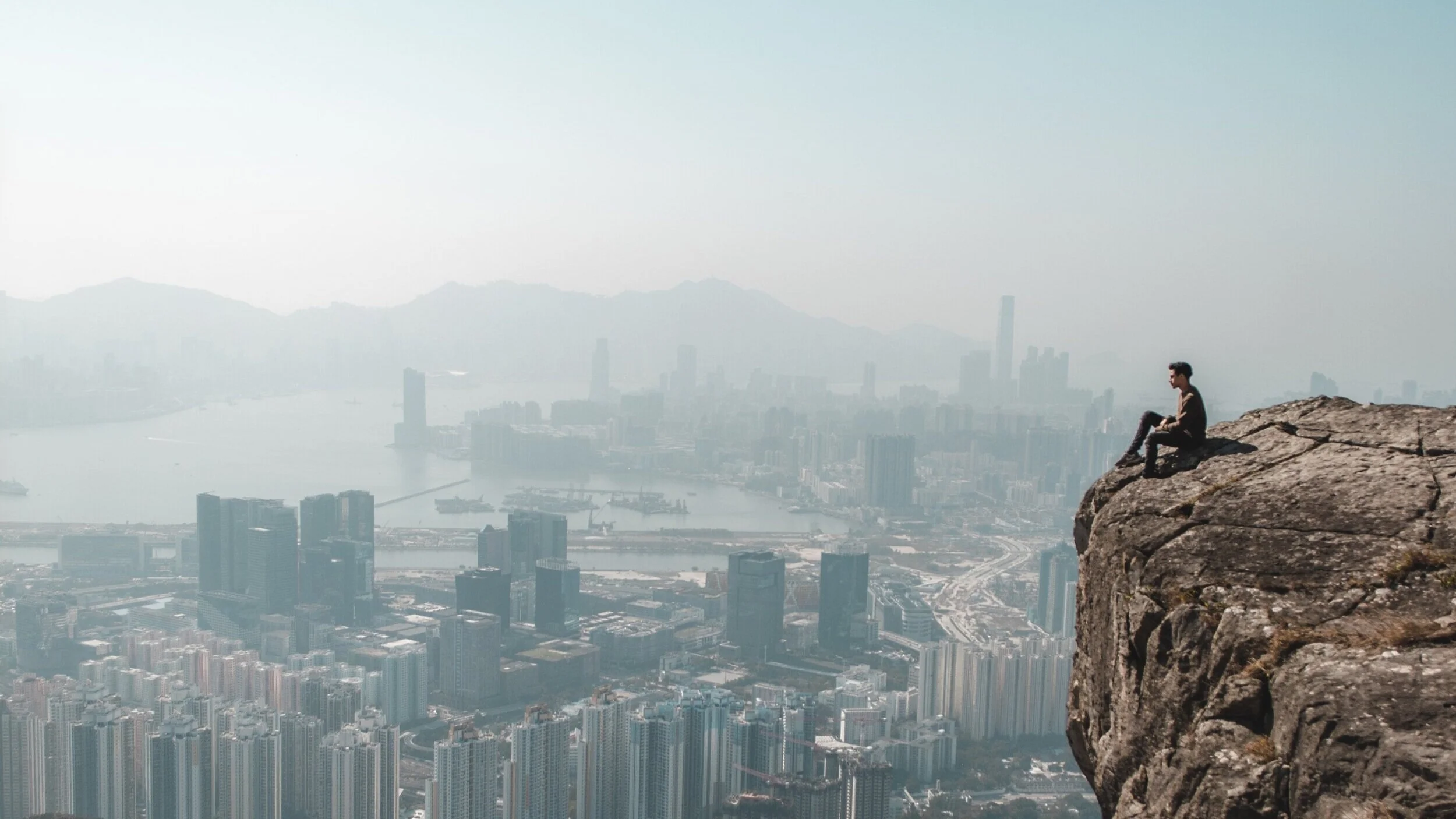 photo-of-man-sitting-on-cliff-3290066.jpg