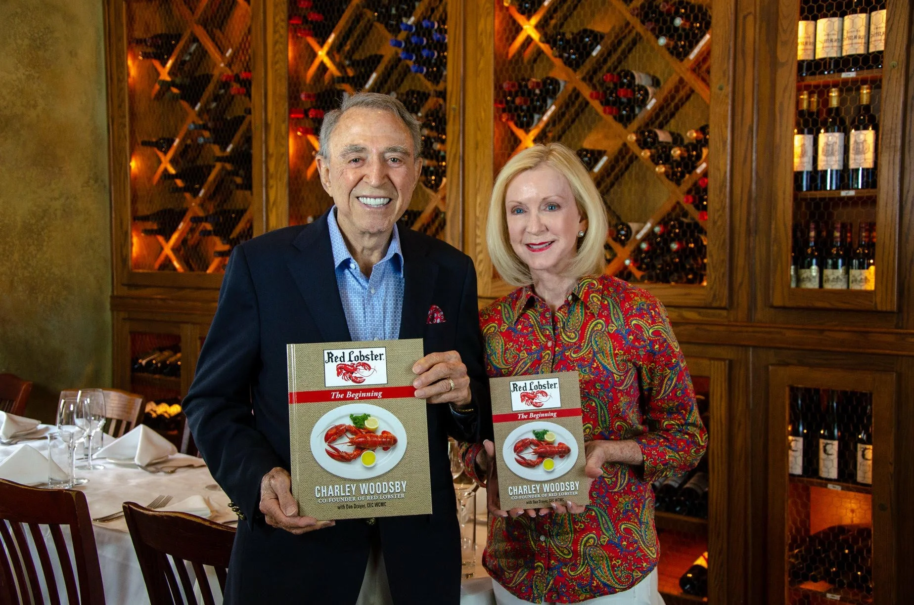 Charley and MaryLou Woodsby with 50 year pictorial history of Red Lobster