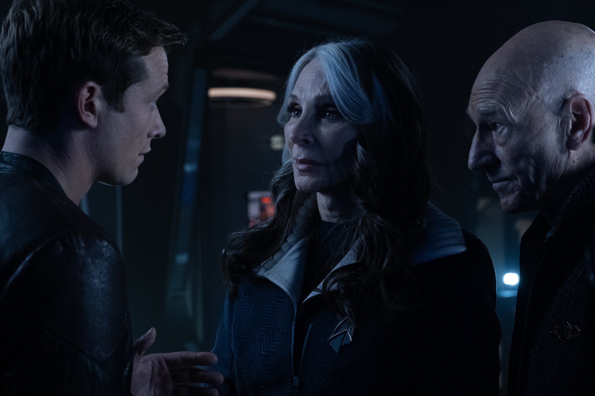   Ed Speleers  as Jack Crusher,  Gates McFadden  as Dr. Beverly Crusher and  Patrick Stewart  as Picard.  Photo Credit: Trae Patton/Paramount+.  