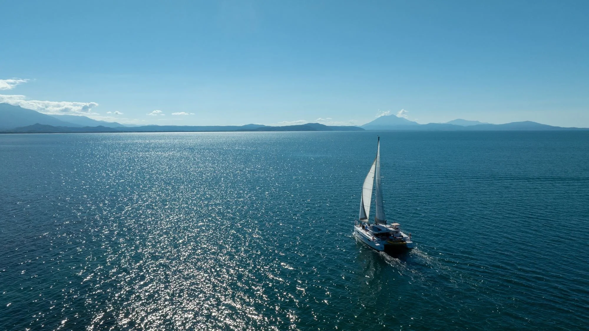aerial-ocean-view-sailboat-coastline.jpg