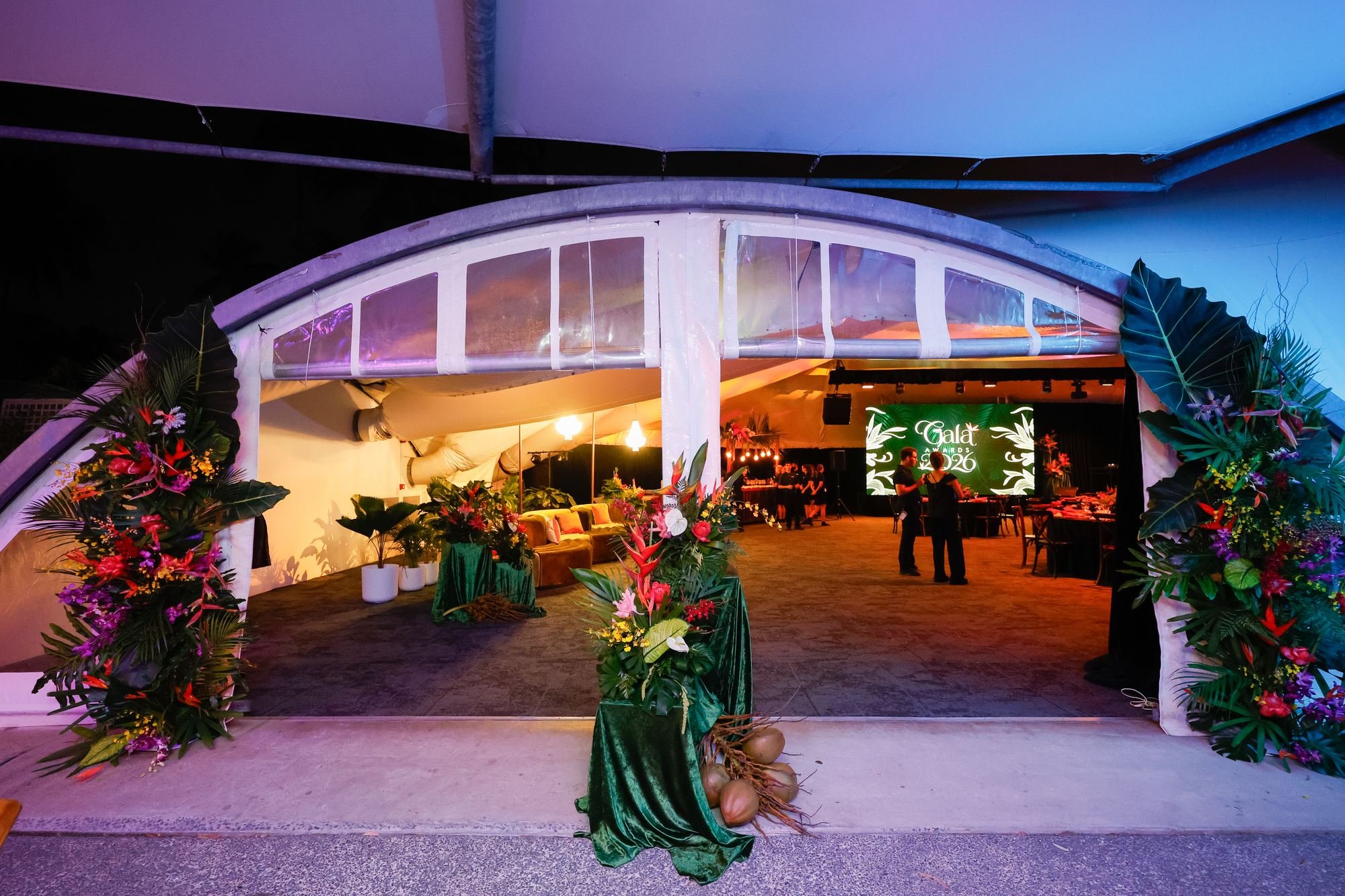 purple-lit-marquee-entrance-tropical-florals.jpg