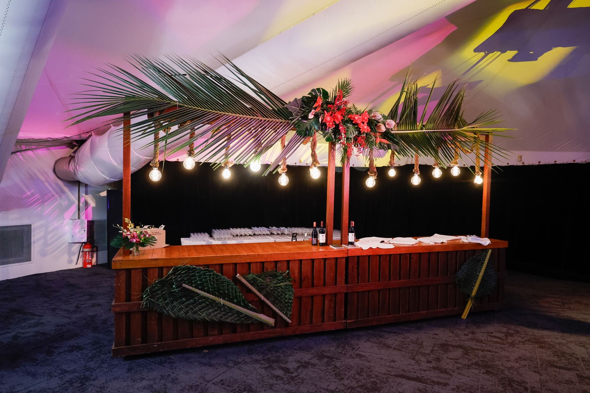 tropical-bar-setup-palm-fronds-string-lights.jpg