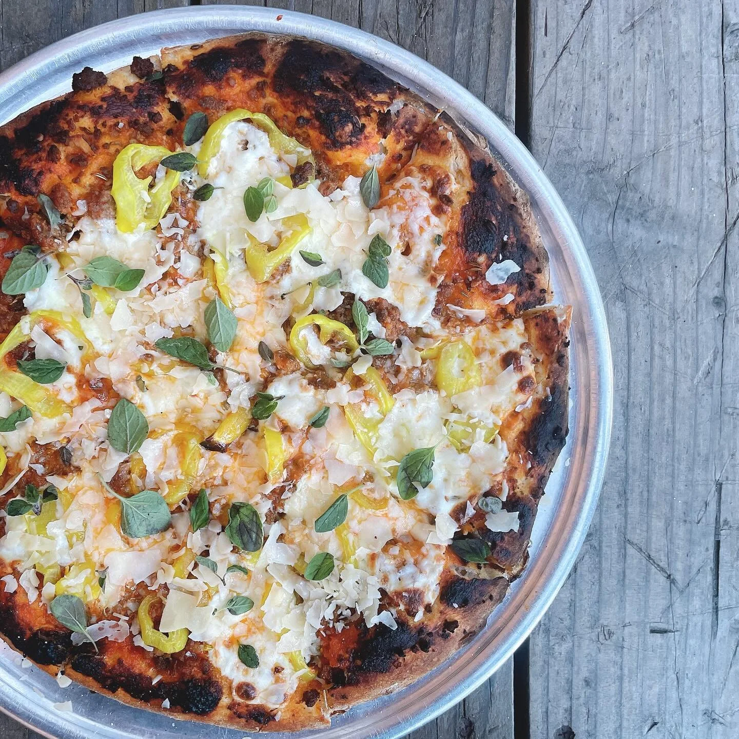 Our “High Spirits” flatbread pizza started as a spooky season special 3 years ago and it never left our menu! 👻 
.
Vodka sauce, house made fennel sausage, pickled banana peppers, fresh mozzarella, oregano, parmesan
.
Dine-in or take-out!