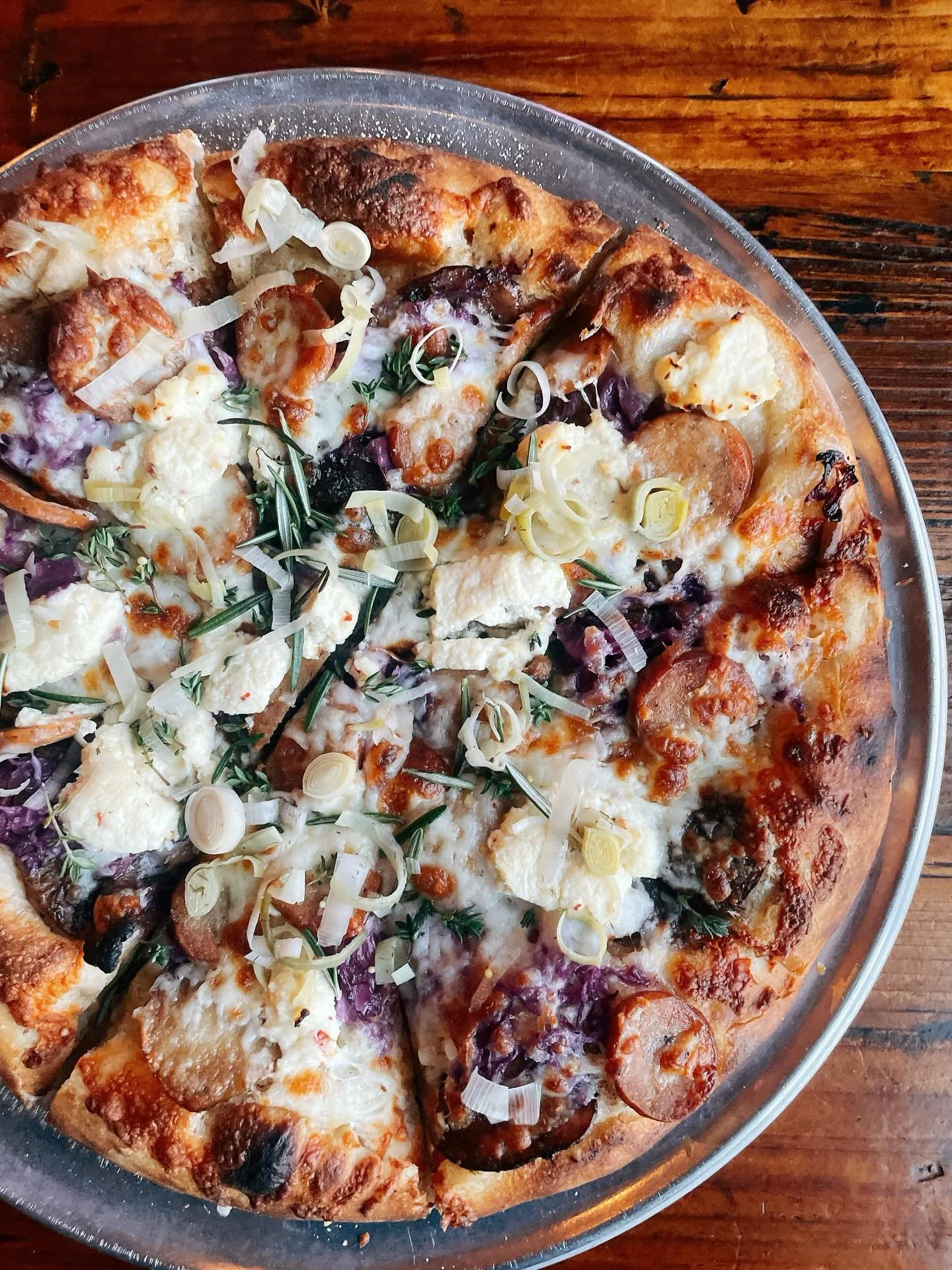 Come try the Perfect Mash. 
.
Mustard garlic oil base, roasted fingering potatoes, polish sausage, braised red cabbage, lemon ricotta, shreddy mozzarella, topped with pickled leeks and herbs.