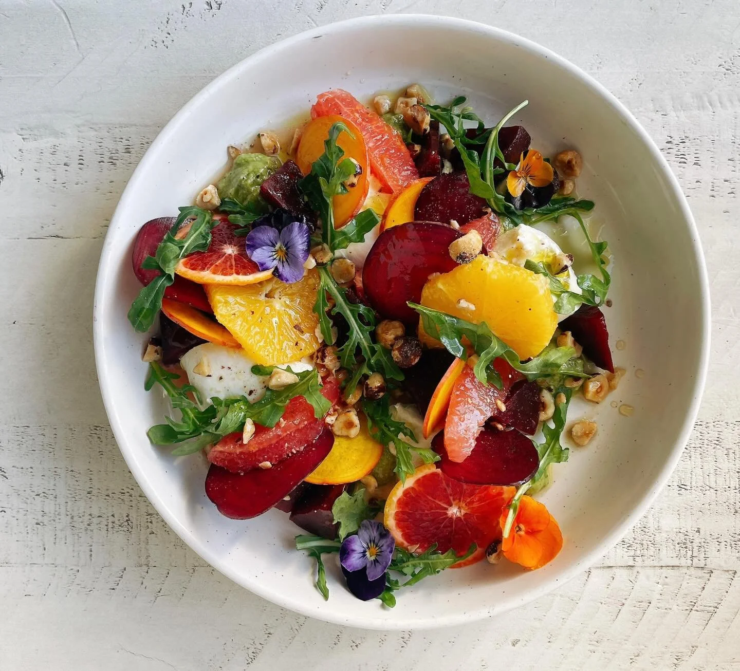 Our winter burrata with roasted beets, shaved beets, grapefruit, blood orange, orange, arugula, avocado horseradish pesto, toasted hazelnuts, lemon oil, white balsamic reduction. 🫜 🍊 🌱