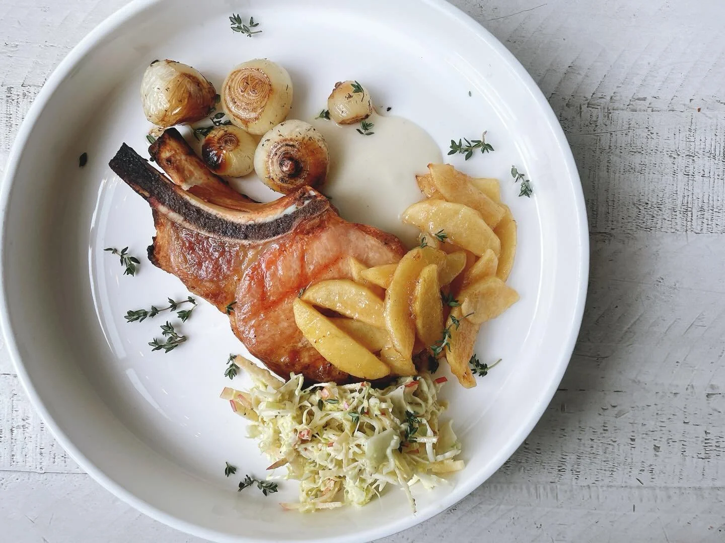 Pork rib chop with baked evercrisp apples, Granny Smith apple puree, apple cabbage slaw, charred pearl onion, thyme. 
.
We&rsquo;re open, come see us!