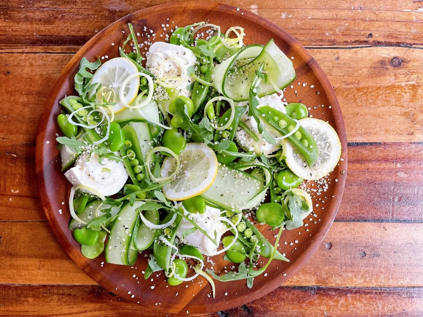 Our springtime burrata has arrived! 🌱 
.
Burrata with sugar snap peas, English cucumbers, favas, leeks, arugula, hemp seeds, lemon oil, white balsamic reduction.