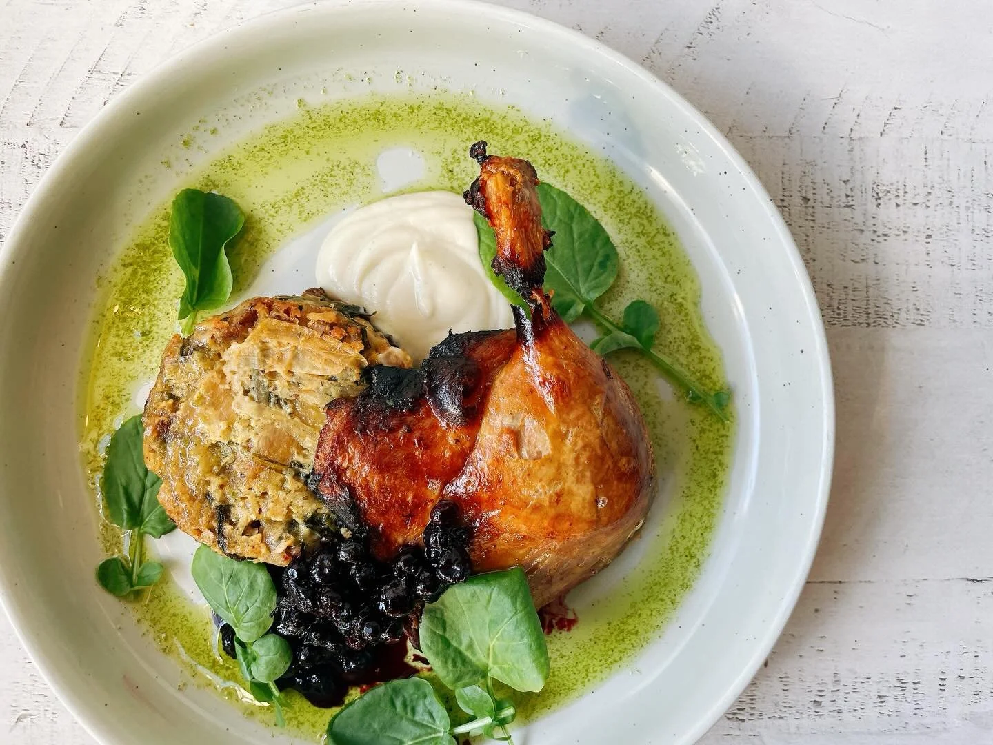 Last week of our duck legs!
.
Served with parsnip pur&eacute;e, caramelized onion arugula savory bread pudding, huckleberry compote, watercress, chive oil