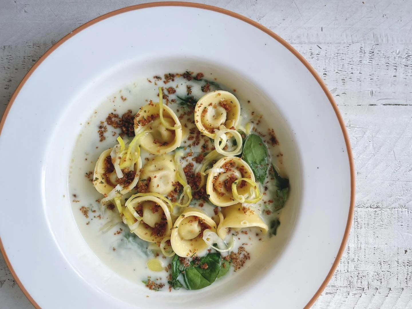 Come try our bacon bourbon cappelletti!
.
Bacon, bourbon, maple syrup filling served with parsnip cram sauce, saut&eacute;ed spinach, breadcrumbs, pickled leeks