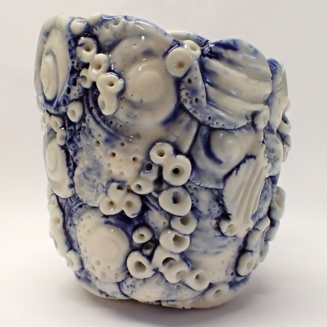 A porcelain Rockpool vessel that reminds me of the Willow Pattern shards I dig up in my rural cottage garden.  The tumbling 'barnacles' and shell fragments are images taken from visits to local rockpools at low tide.  While this series is of ceramic 