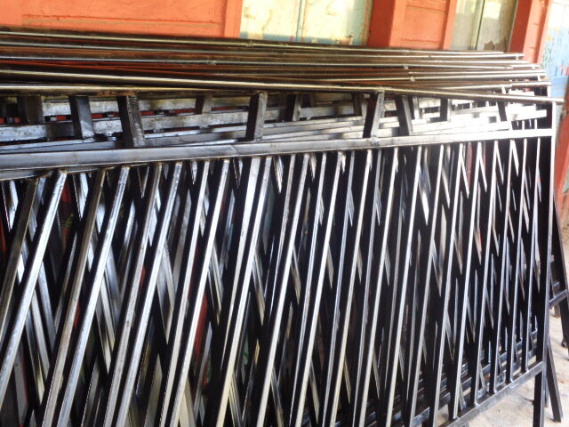 Iron handrails for the exterior school stairway are ready to be installed.