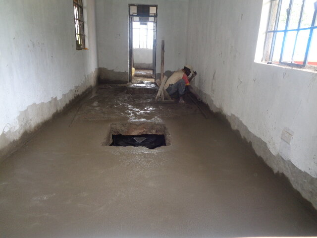 A workman is completing a floor inside the school during the school’s co