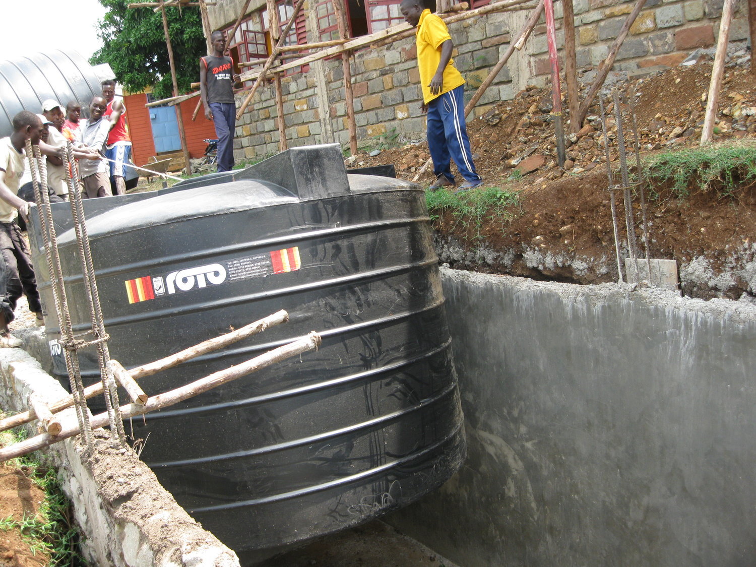 Lowering a Water Cistern into its New Home