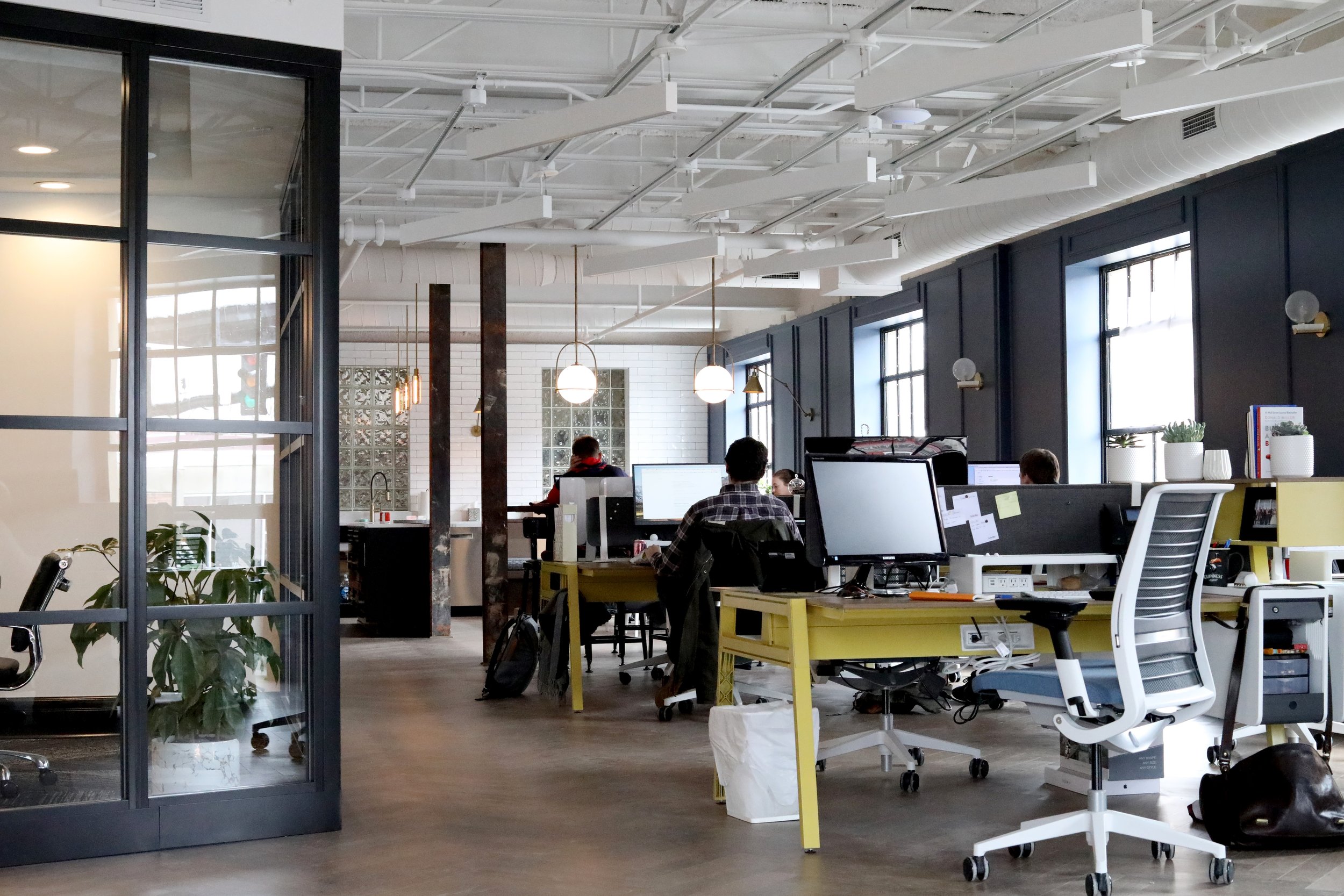  Open concept office space with people working at their desks 