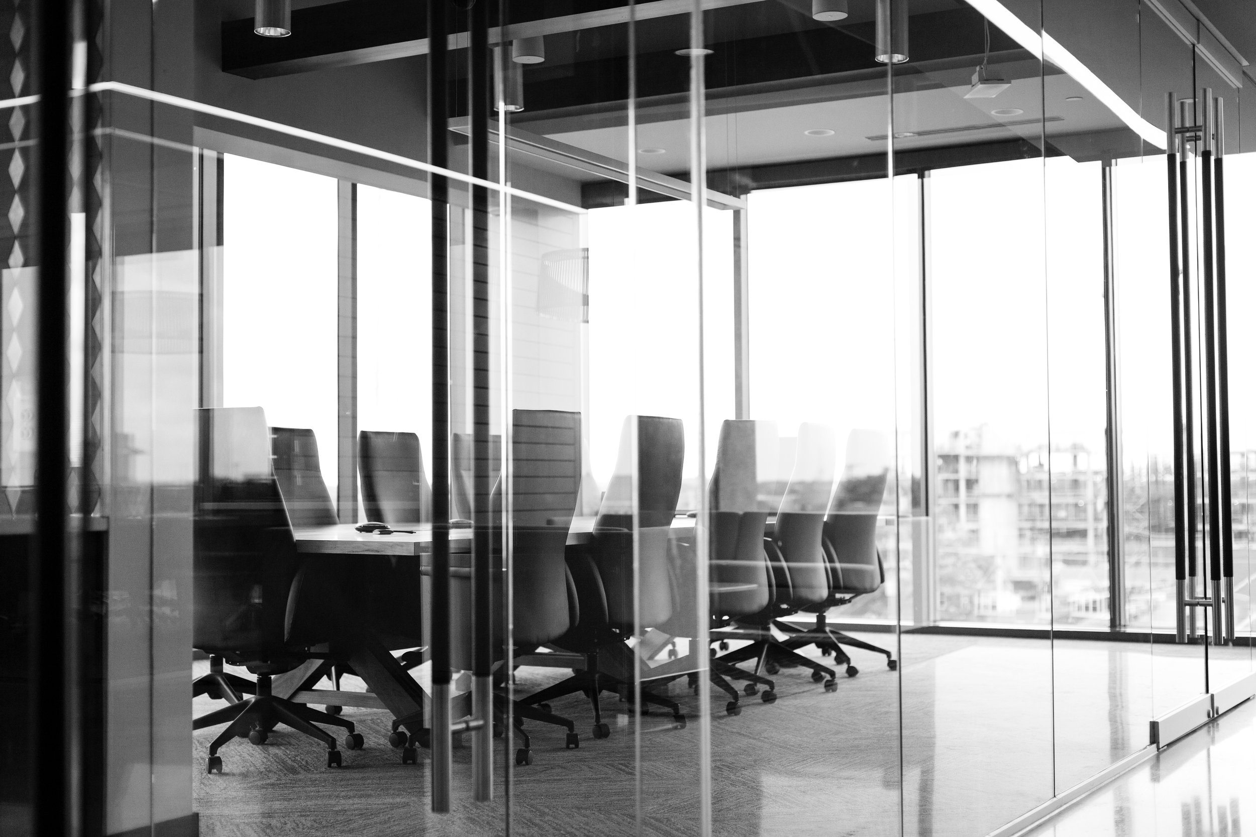  Black and white image of a conference room. 