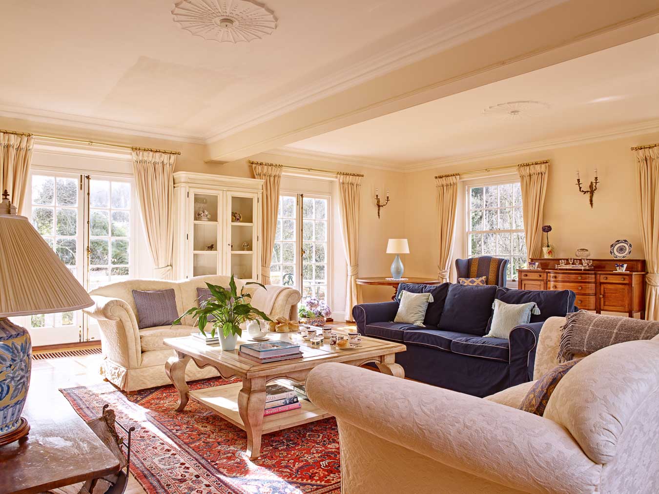 The comfortable sofas and large french doors leading onto the sun terrace at Flear House, Flear Farm. 