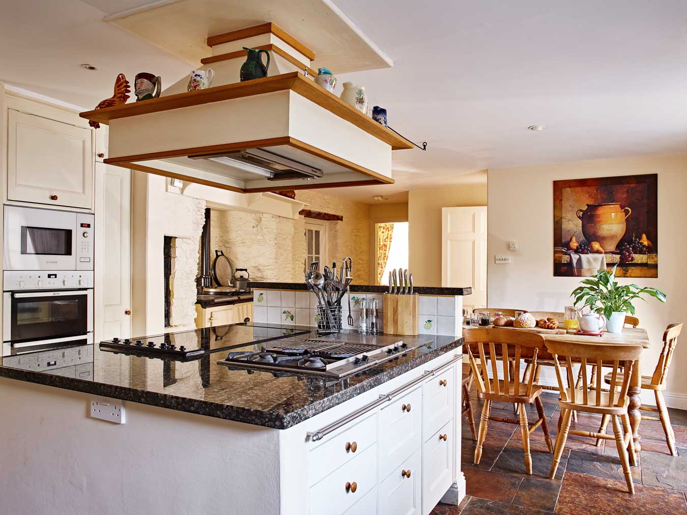 Flear House kitchen with is oven stack, electric hobs and gas burner.