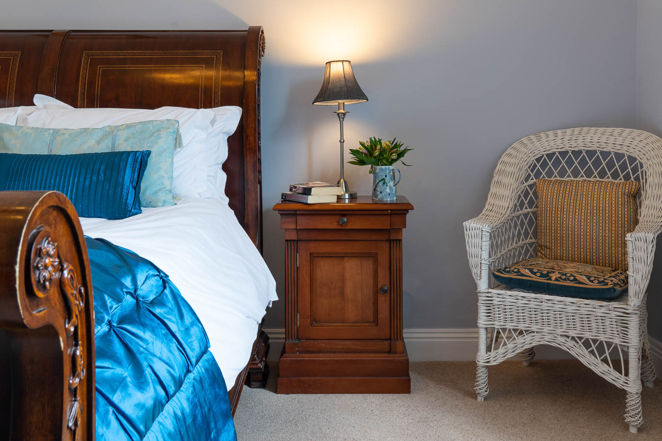 Mahogany bedside table and sleigh kingsize bed in the Blue room in Flear House.