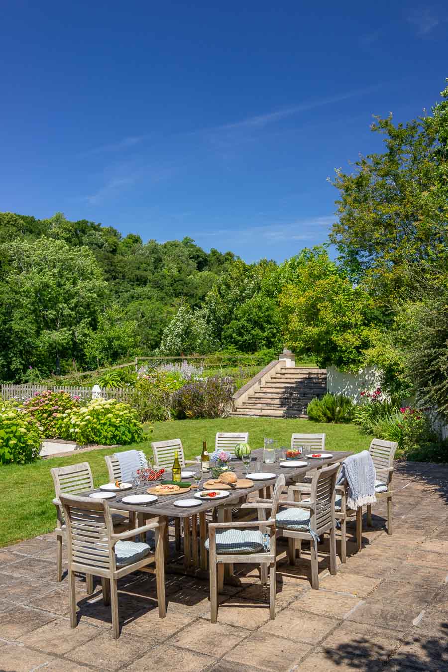 BBQ terrace, large teak table and extensive mature gardens of Flear House Devon. 