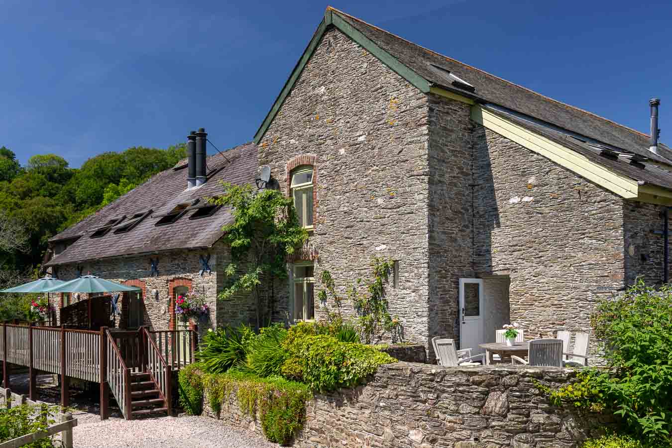 The beautiful stone buildings of Flear Farm holiday cottages. With sun terraces and mature gardens. 