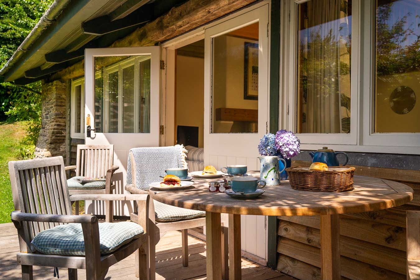 The west facing private decking situated in the Linhay cottage's garden just off the open plan living room. Complete with teak garden furniture at Flear Farm cottages. 