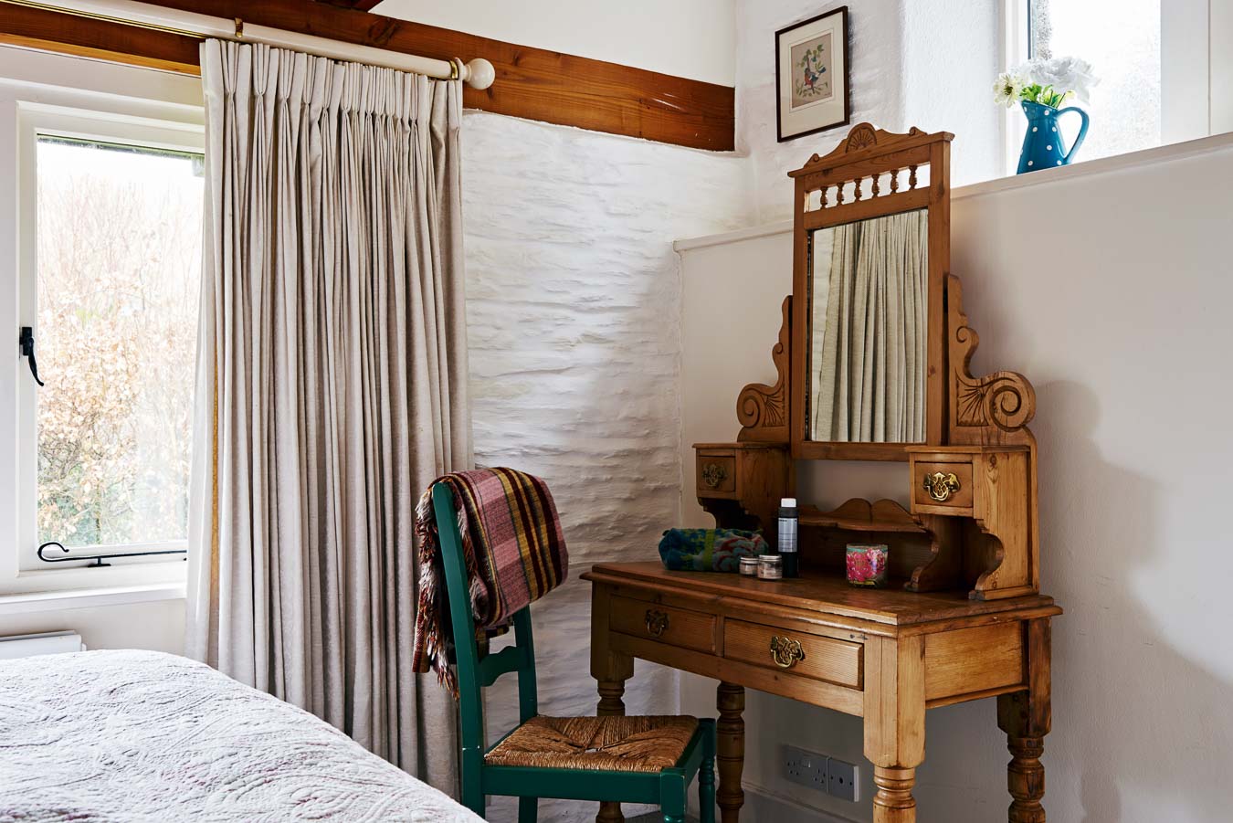 The Linhay's master bedroom dressing table and large windows looking into private garden at Flear Farm.