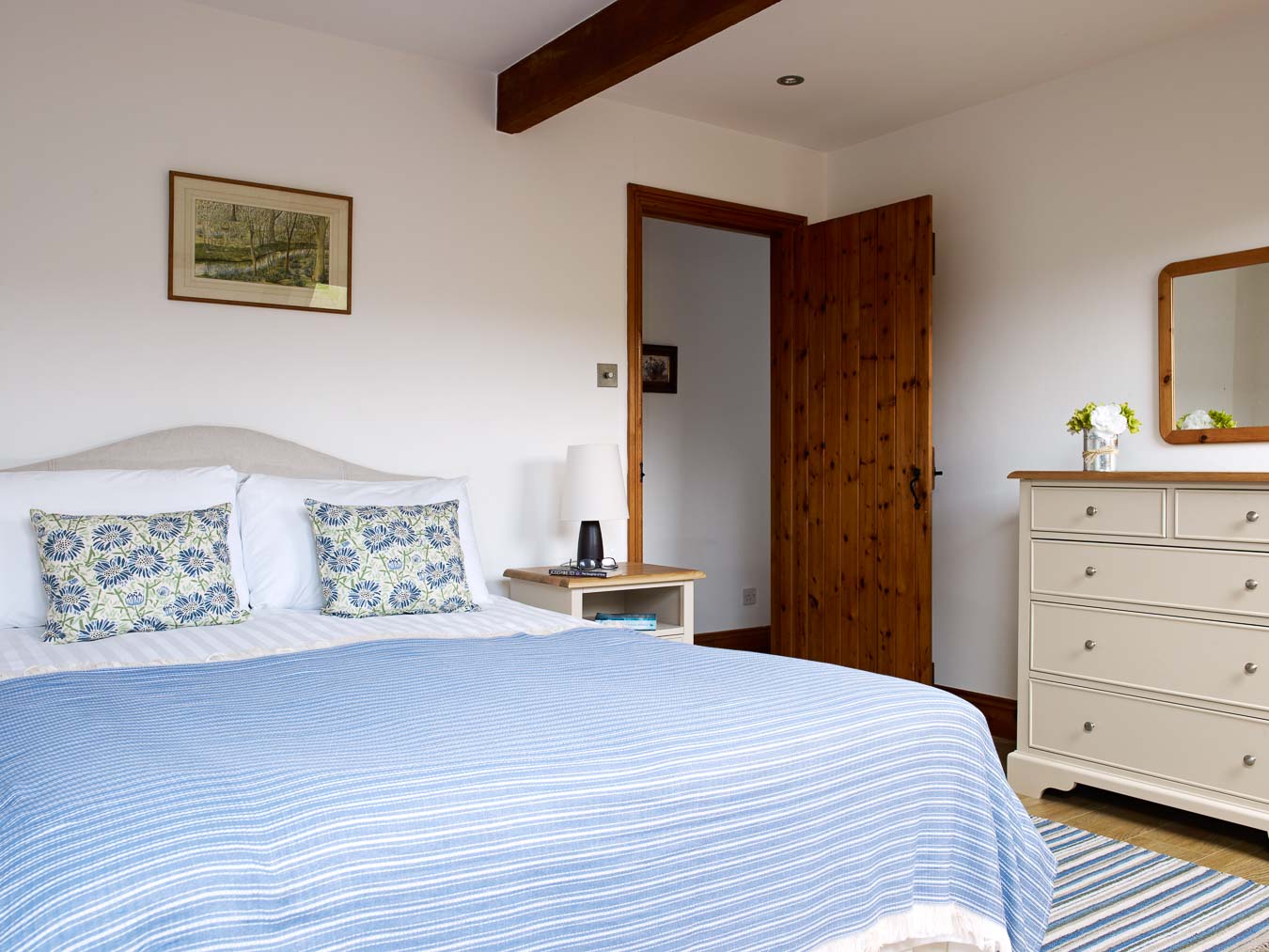 The spacious master bedroom with king size bed and matching bedroom furniture at Cartwheel cottage Flear Farm. 
