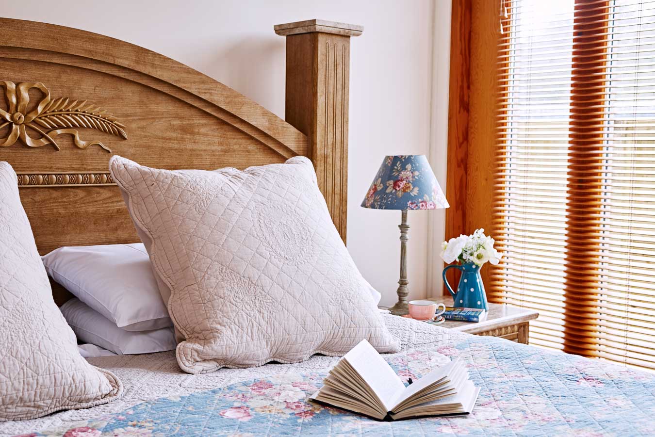 The master bedroom in Orchard Loge offers a superking bed of huge proportions . Luxury bedding and oak framed french doors on to private and secluded decking. 