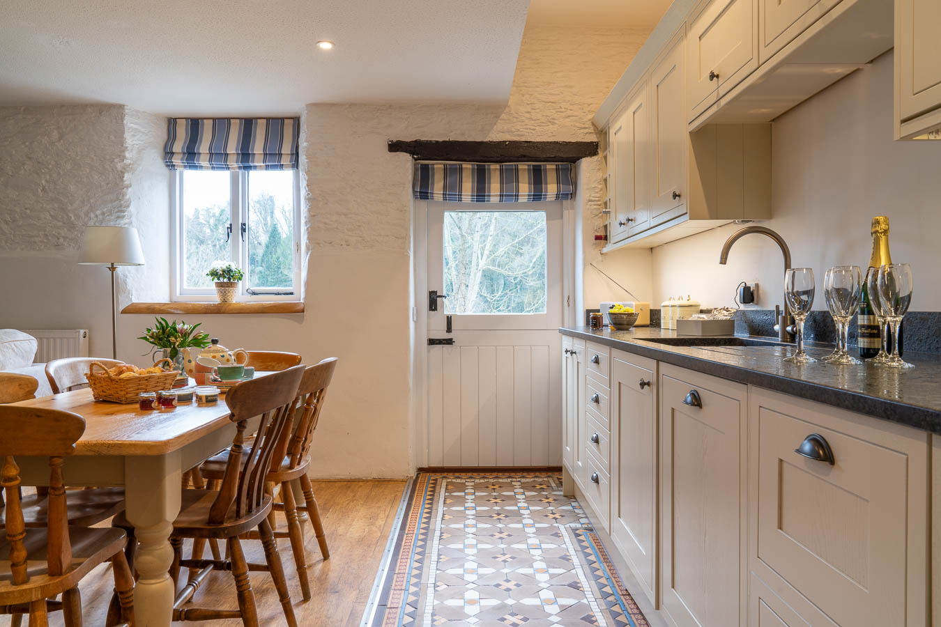 The well appointed Kitchen in The Sables Cottage at Flear Farm. With charming floor tiles and granite work tops the stable door looks out onto the private garden. 