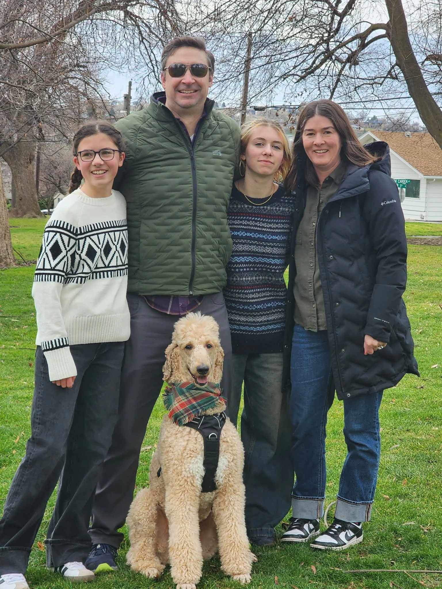 Family with apricot Standard Poodle in a guardian home setting at Valaurah Farms in Oregon