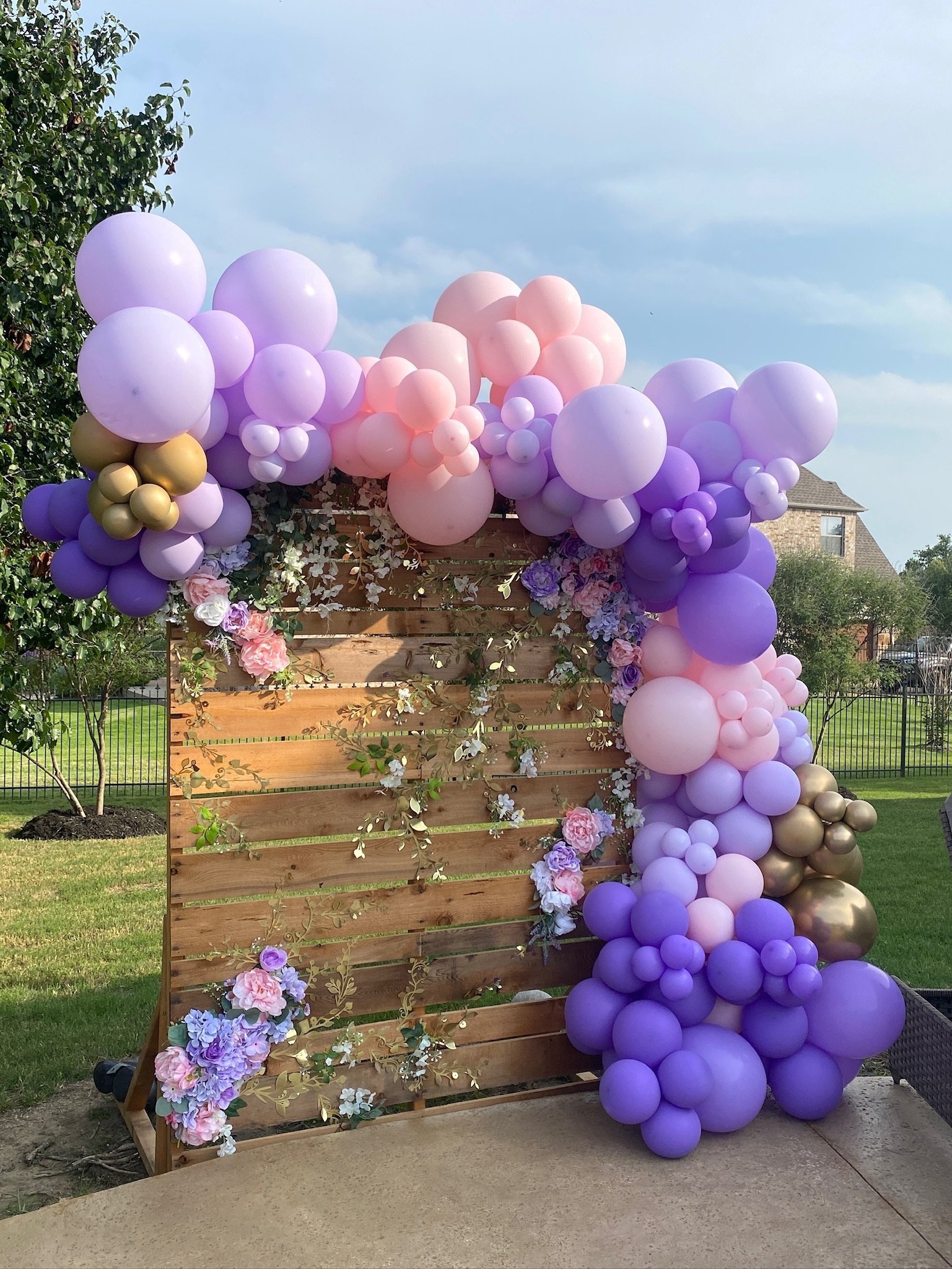 Organic balloon arch in shades of purples and pinks.