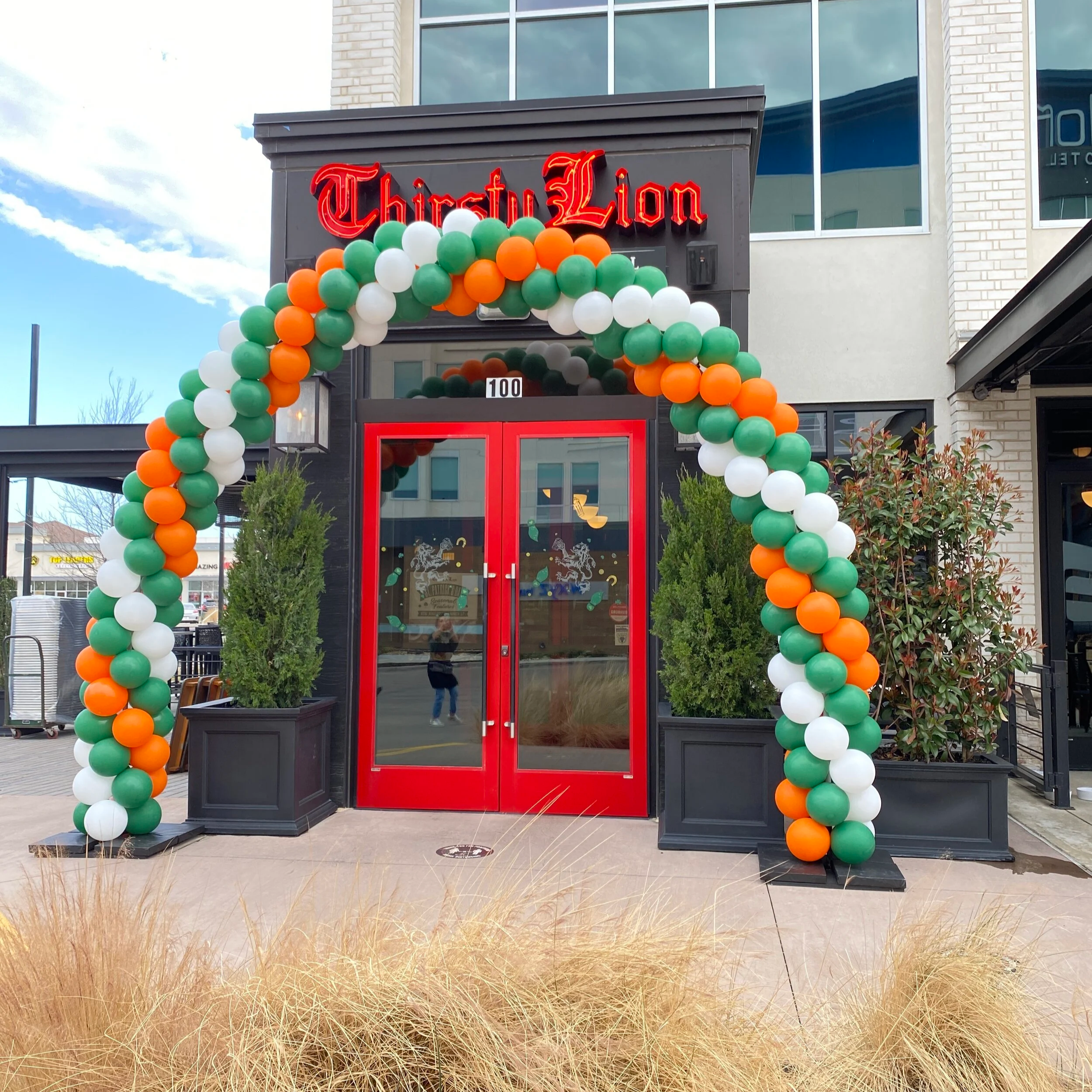 Grand opening balloon arch installation at restaurant storefront in Dallas Fort Worth