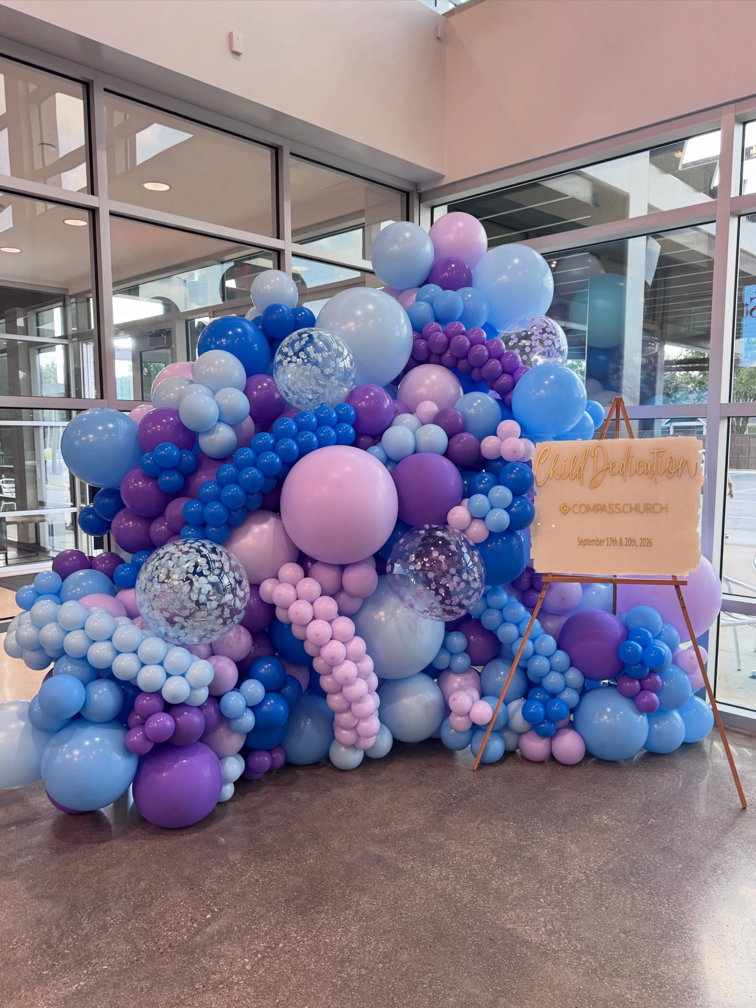 A special weekend celebrating little ones at Compass Christian Church in Colleyville. 💙💜

We created this statement balloon wall for Child Dedication weekend, layering shades of blue and lavender with confetti details for the perfect photo moment f