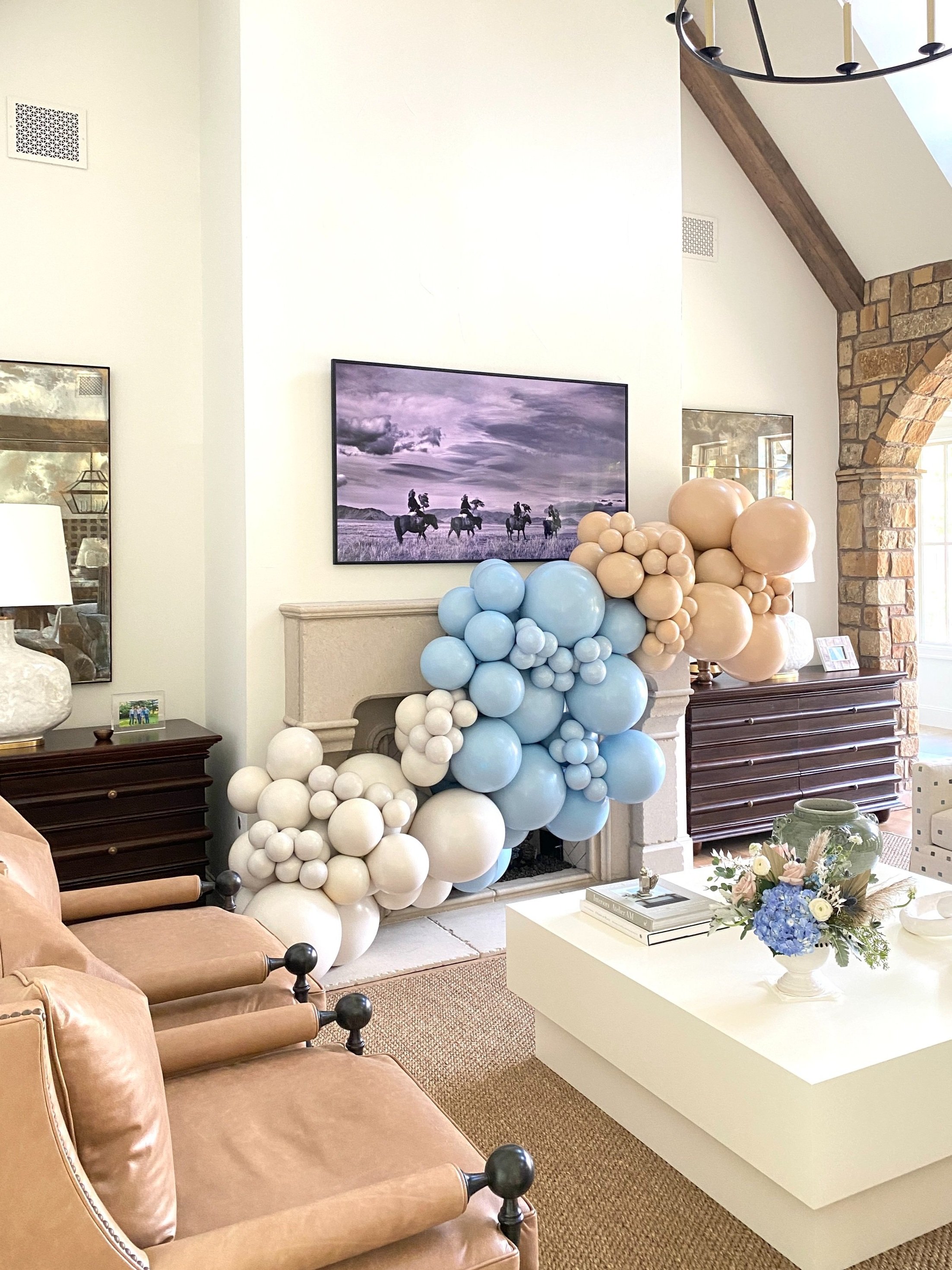  Baby shower organic balloon arch in soft muted colors on fireplace 