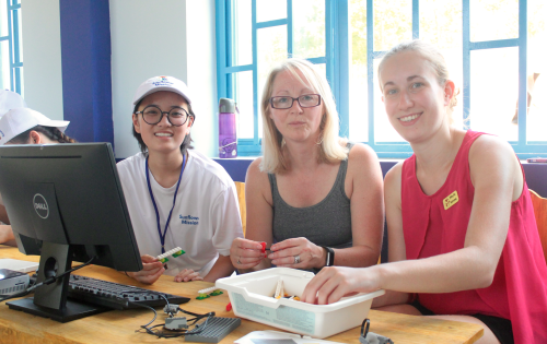 Emily Nguyen (left) and her team train for the LEGO robotics workshop. (Photo: Dan Q. Dao)