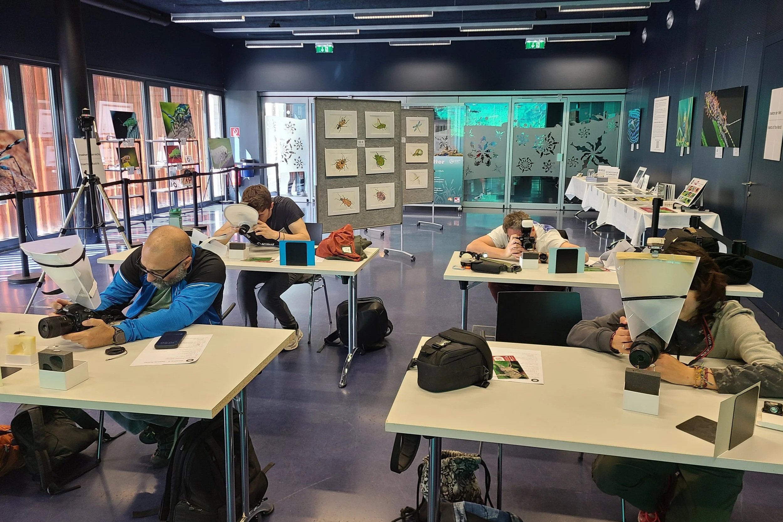 workshop-b-wide-participants-leaning-over-table-photographing-specimens.jpg