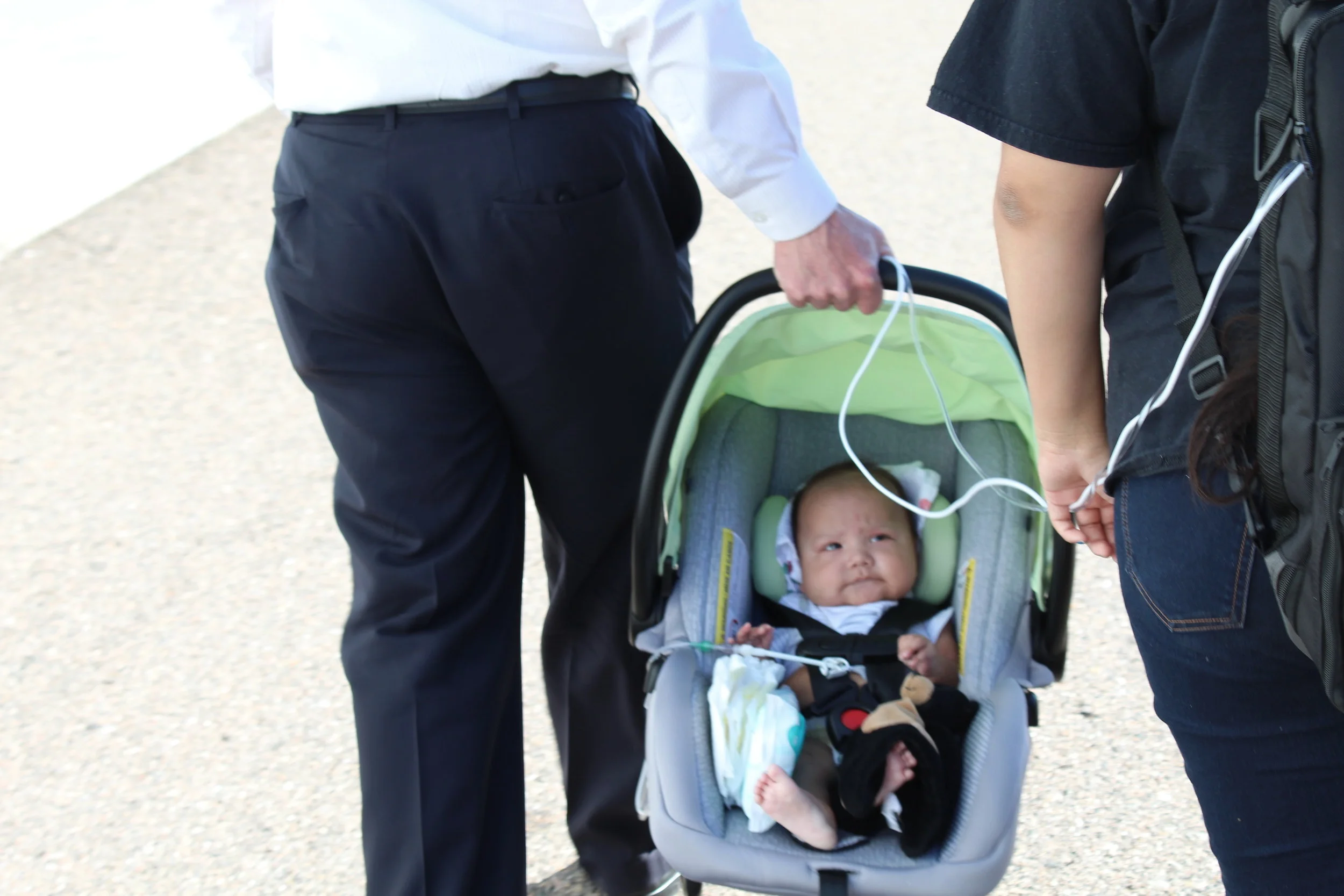 AeroAngel President Mark Pestal carrying Taehung, 5 months, with mother Layla Jacket.