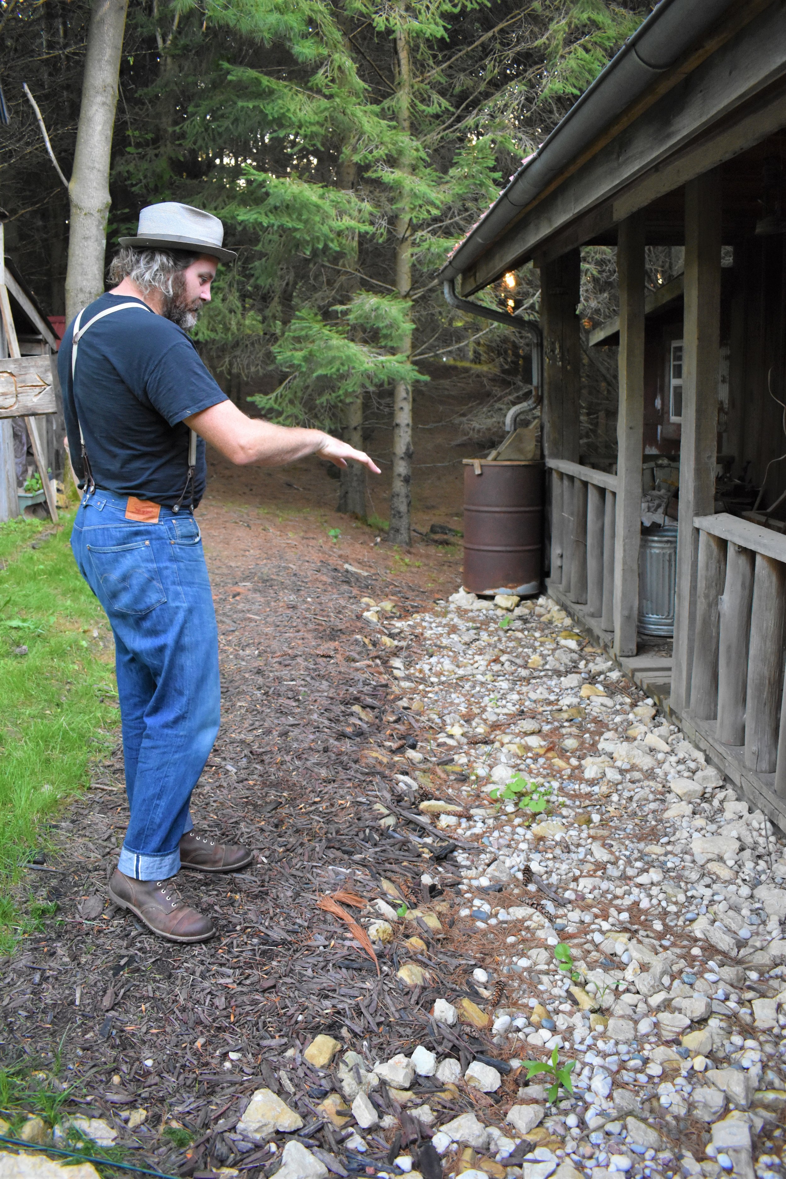 Lou describes where the metal sheets were laid that keep water from going under the cabin and reroutes it off to the side