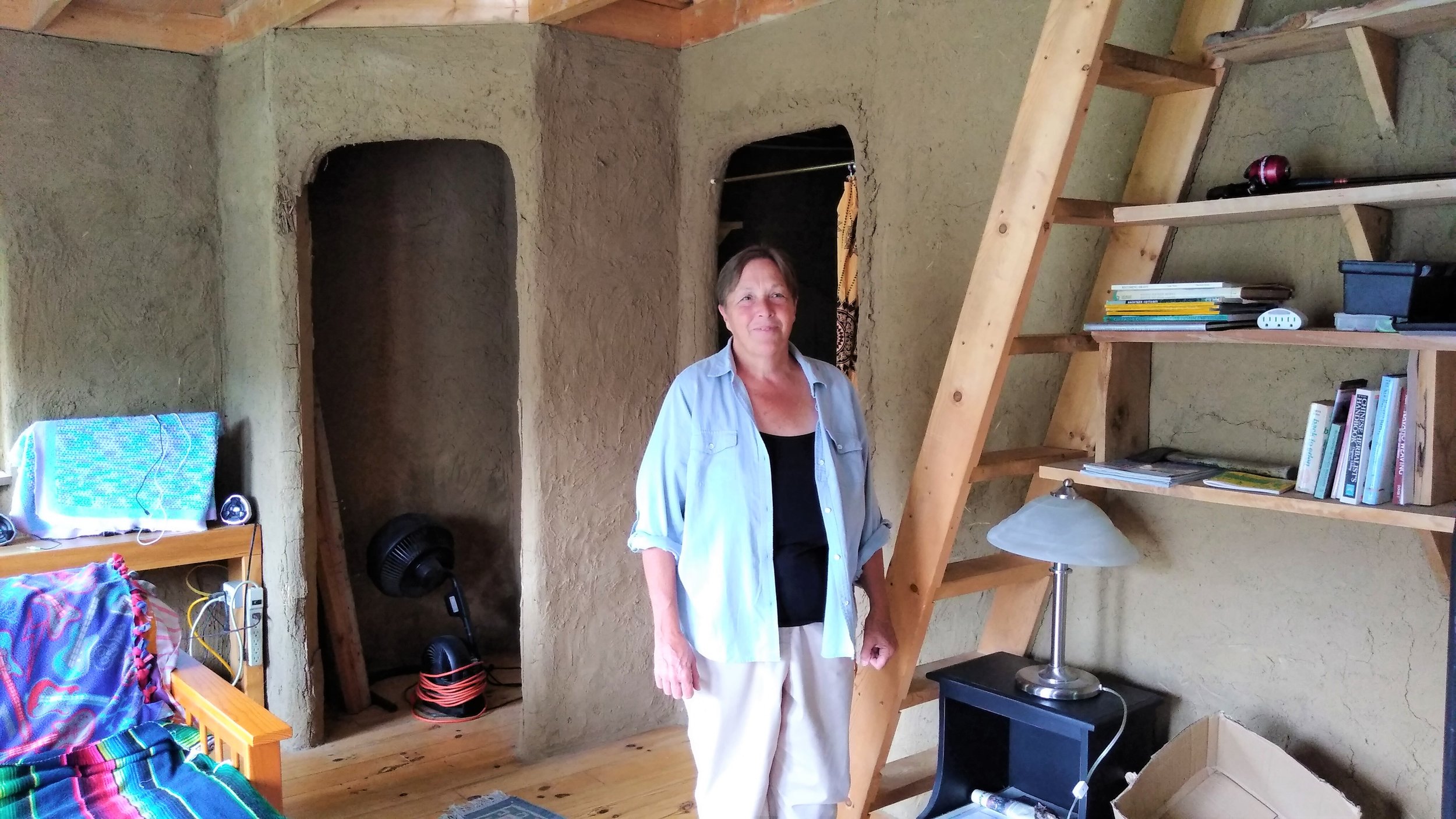  Dena inside one of the houses that is made of clay and straw 
