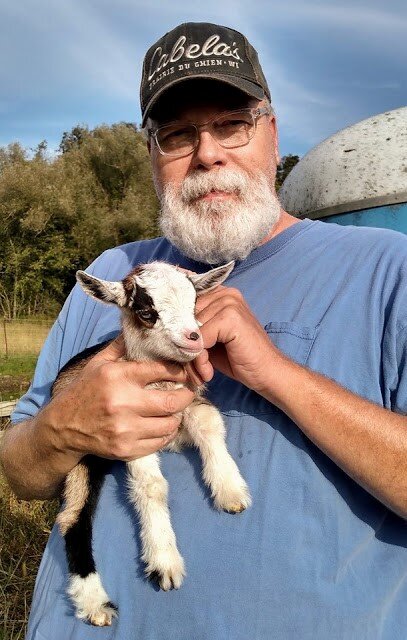    An Old Goat held a young goat.   
